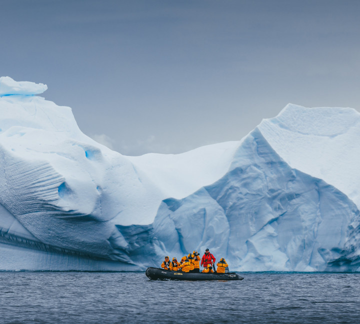 Quark Expeditions guests go Zodiac cruising with their Expedition Guide in the Antarctica Peninsula.