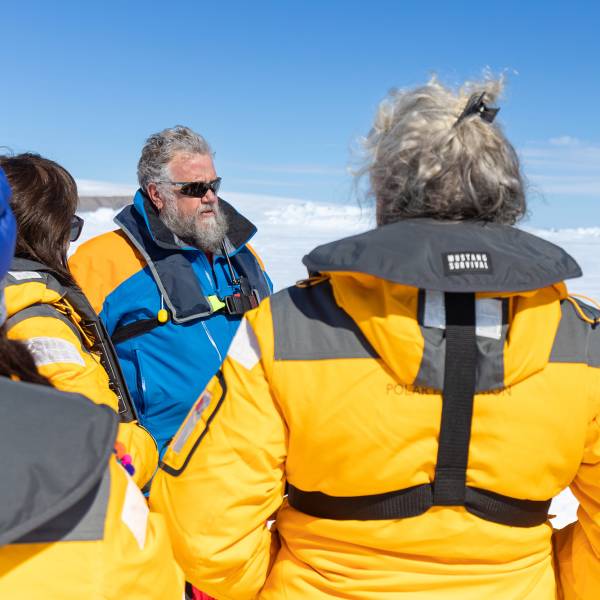 Expedition leader talking to guests on a landing site