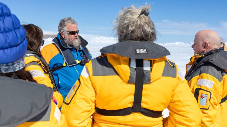 Expedition leader talking to guests on a landing site