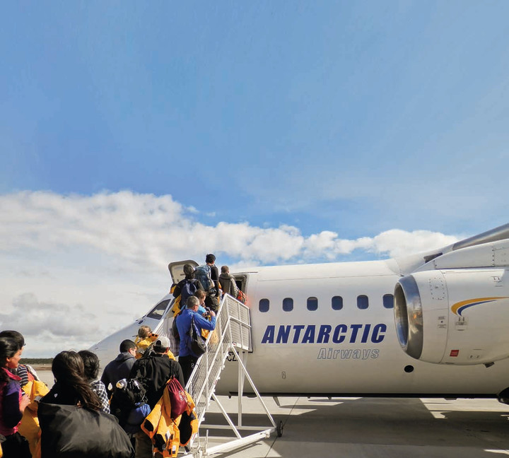 Guests going up stairs as their board our chartered flight from Punta Arenas, Chile.