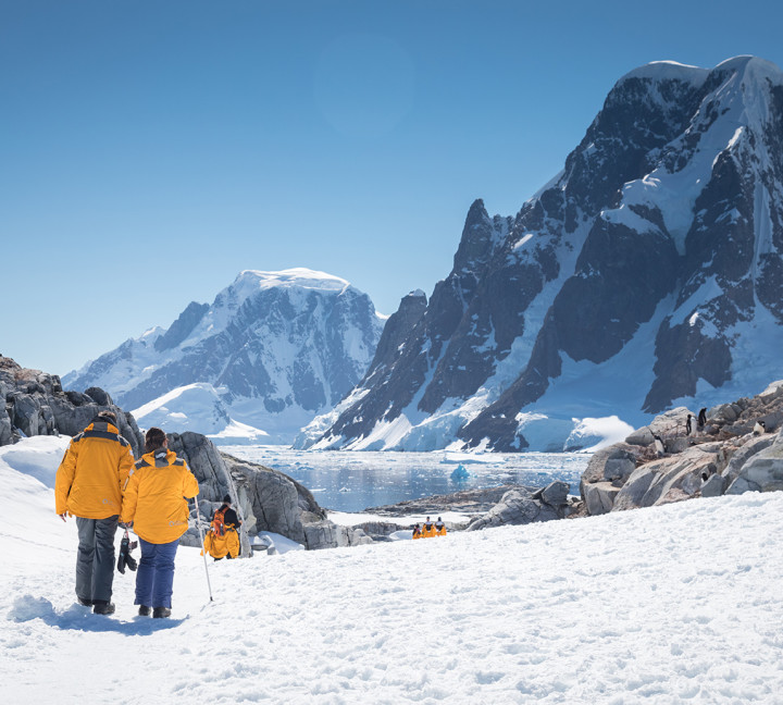 Guests hike through the snow at Petermann Island in the Antarctica Peninsula.