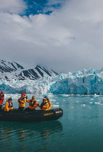 Quark Expeditions guests explore Svalbard during a Zodiac cruise.